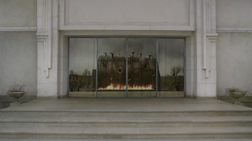 Fig 3. The viewer watches the drum in the reflection of the windows